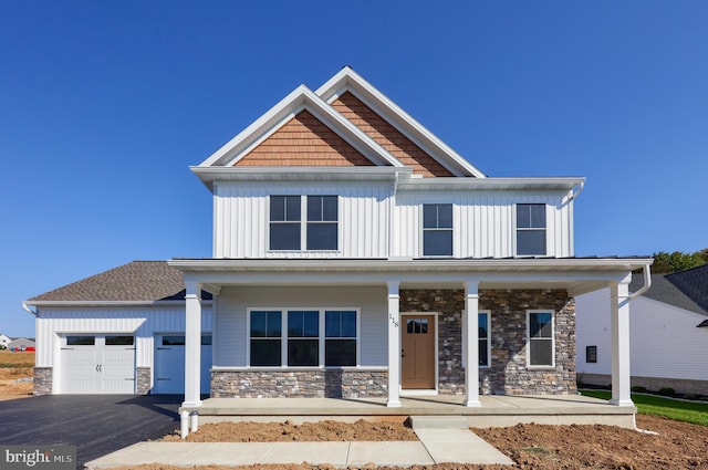 craftsman-style house featuring a garage and covered porch