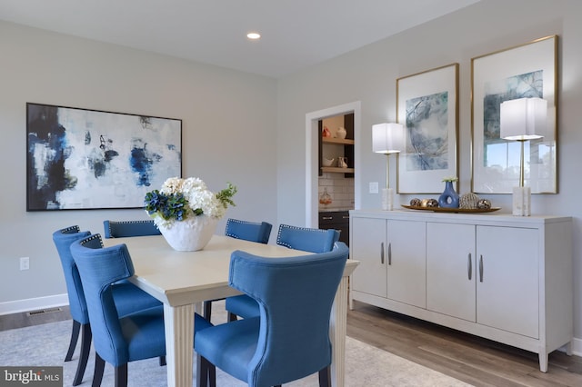 dining area with light hardwood / wood-style floors