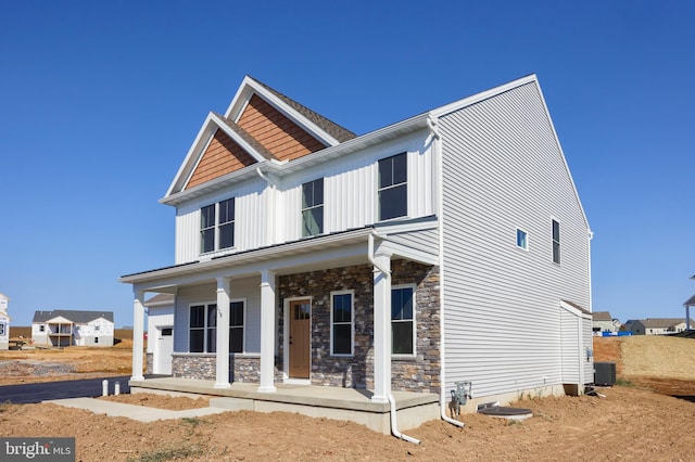 view of front facade featuring covered porch and central air condition unit