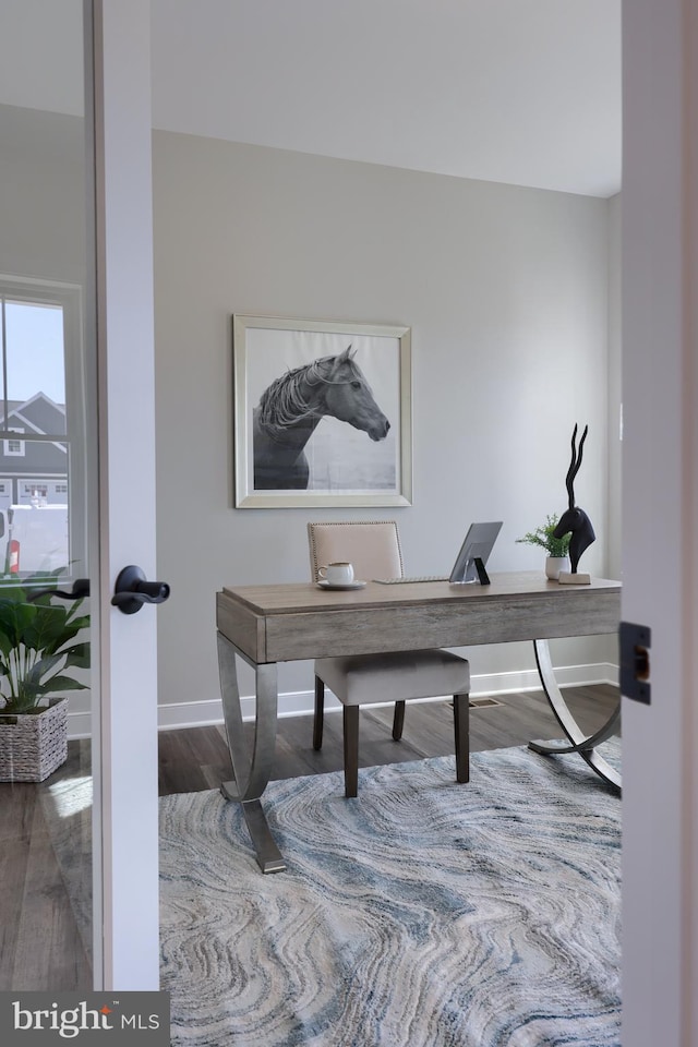 home office with dark wood-type flooring