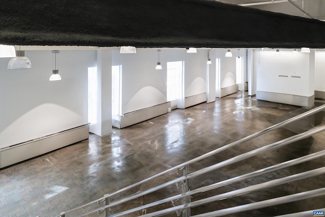 interior space with concrete floors and a baseboard heating unit