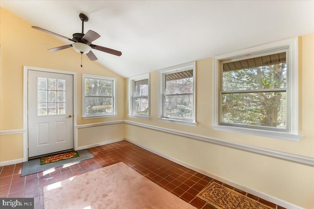 unfurnished sunroom featuring ceiling fan and vaulted ceiling