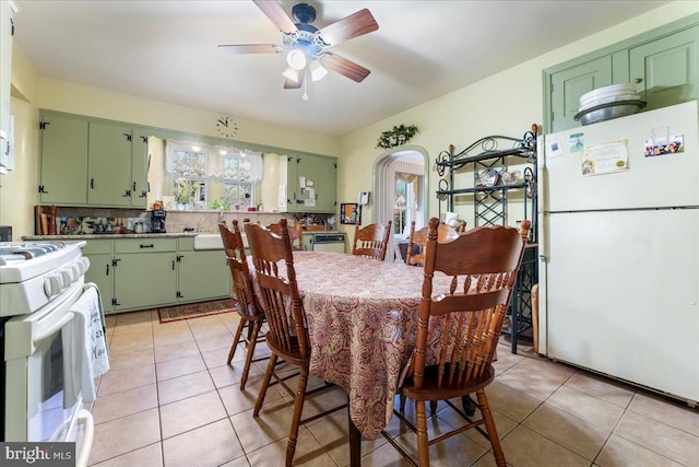 tiled dining space featuring sink and ceiling fan