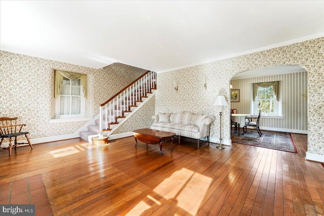 living room with wood-type flooring and ornamental molding