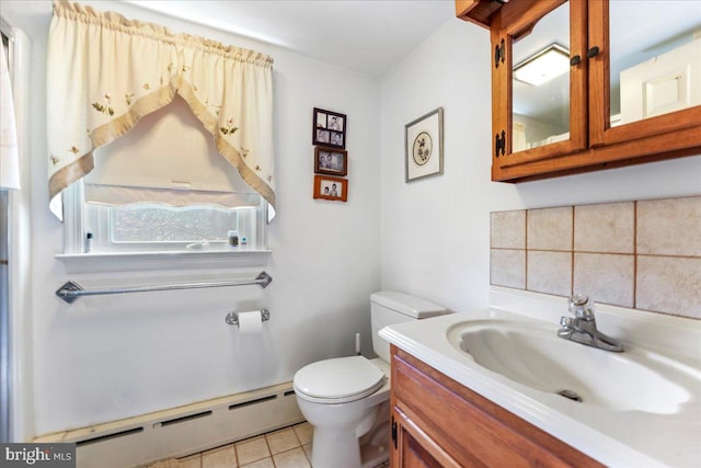 bathroom featuring vanity, tile patterned flooring, toilet, and a baseboard heating unit