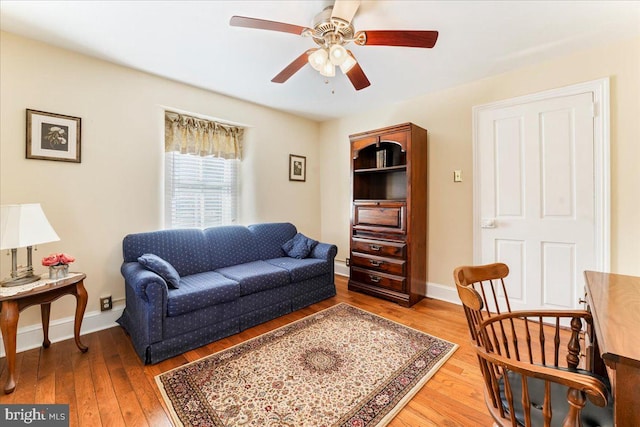 living room with hardwood / wood-style floors and ceiling fan