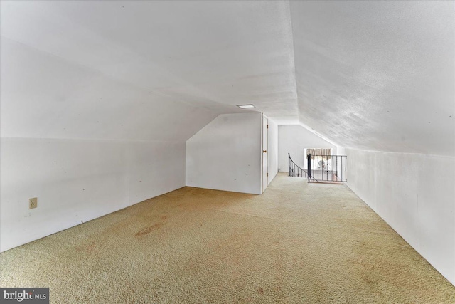 bonus room featuring light carpet and lofted ceiling