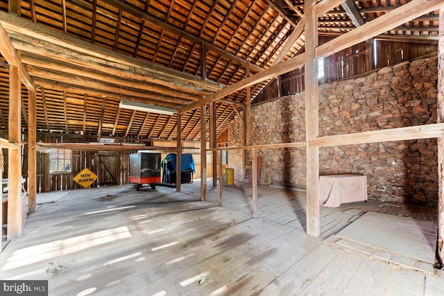 miscellaneous room featuring high vaulted ceiling