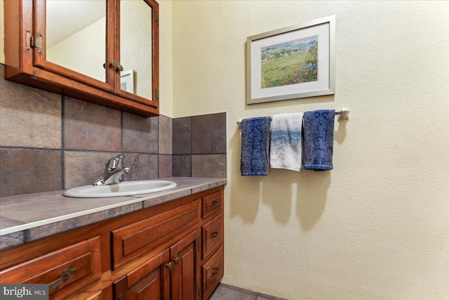 bathroom featuring tasteful backsplash and vanity