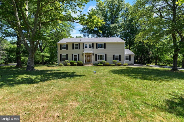 colonial house featuring a front lawn