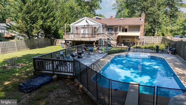 view of pool featuring a lawn and a deck