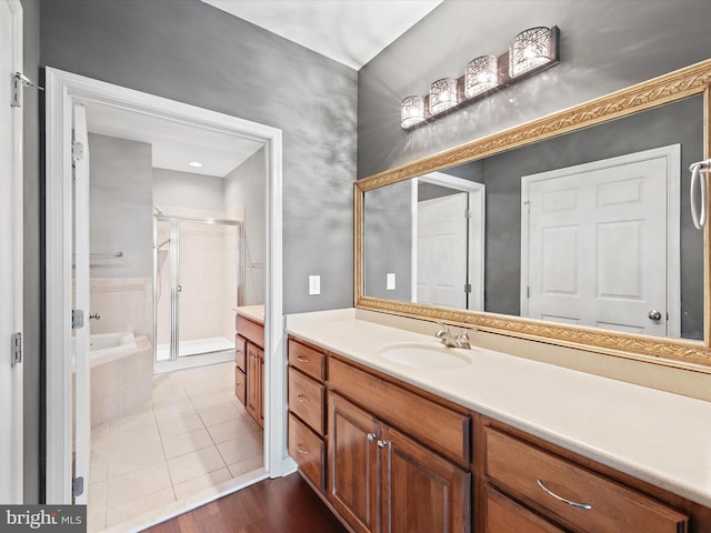 bathroom with tile patterned floors, vanity, and separate shower and tub