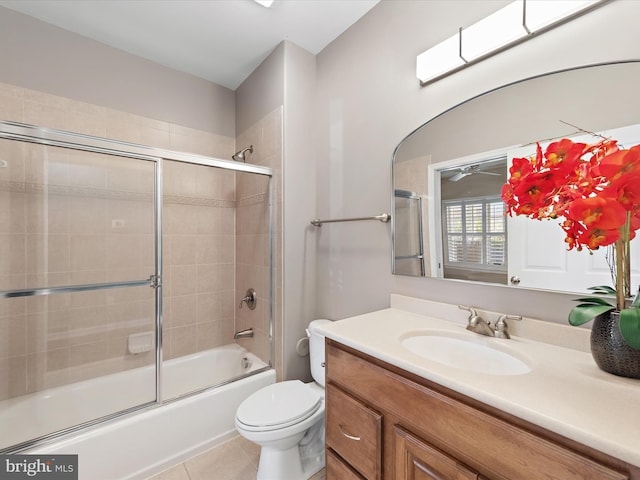 full bathroom featuring tile patterned floors, vanity, combined bath / shower with glass door, and toilet