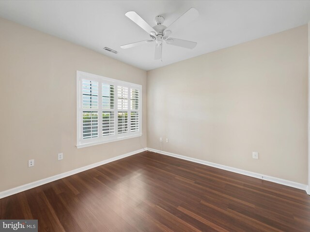 unfurnished room featuring ceiling fan and dark wood-type flooring