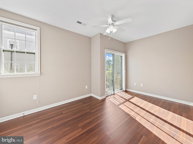 spare room featuring ceiling fan and dark wood-type flooring