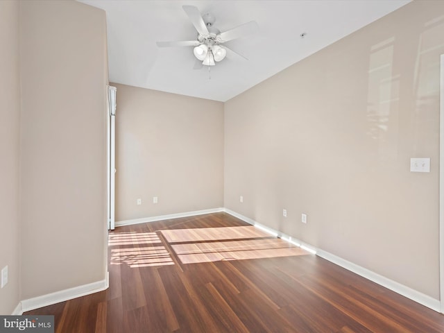 spare room featuring ceiling fan and dark hardwood / wood-style floors