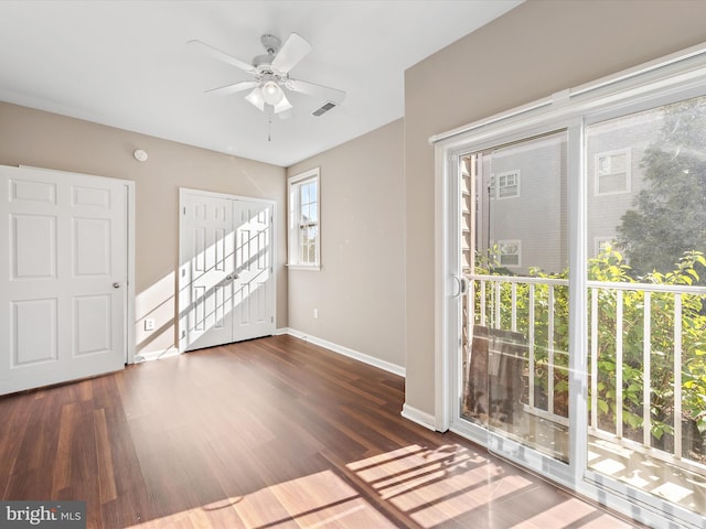 interior space with ceiling fan, dark hardwood / wood-style flooring, and a wealth of natural light