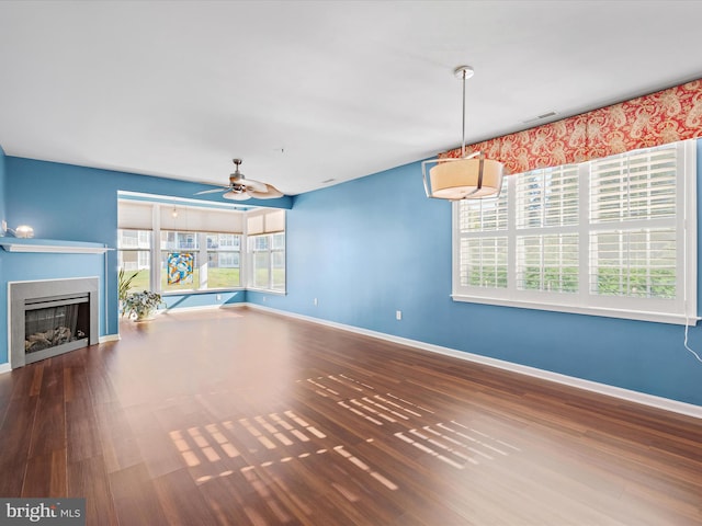 unfurnished living room with hardwood / wood-style flooring and ceiling fan