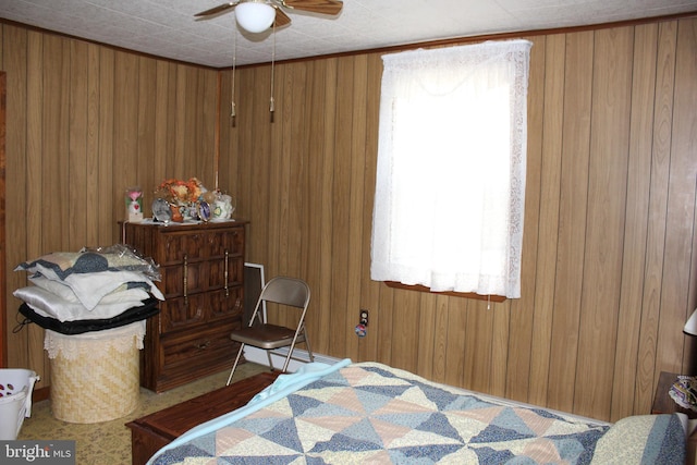 bedroom with wood walls and ceiling fan