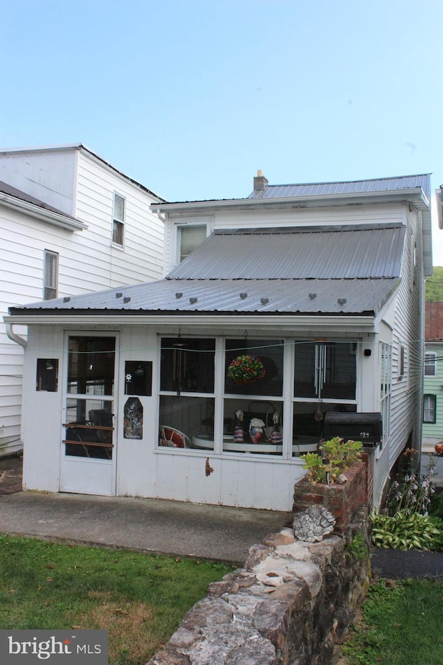 back of house with a sunroom