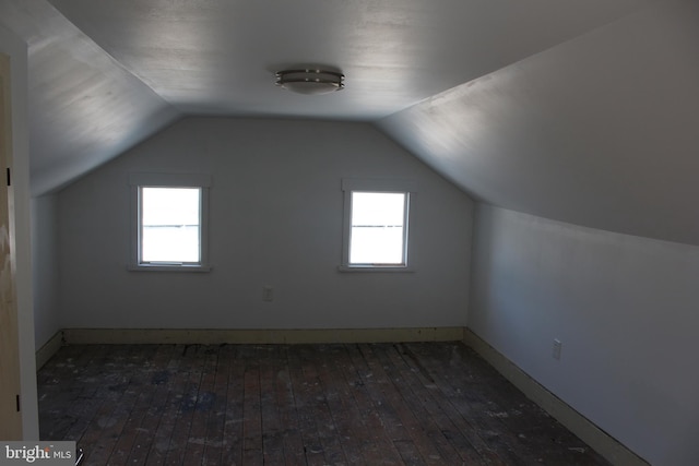 bonus room featuring dark wood-type flooring and lofted ceiling