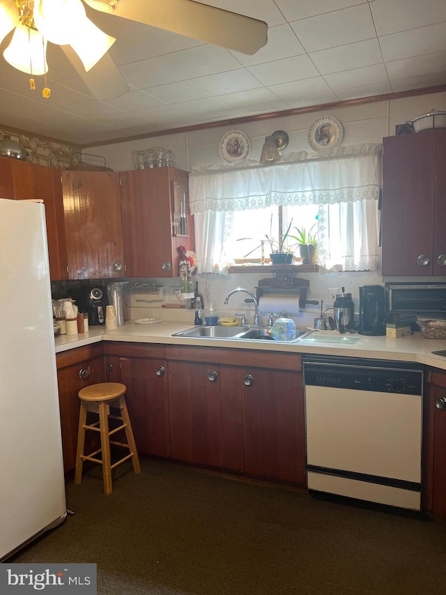 kitchen with ceiling fan, sink, and white appliances