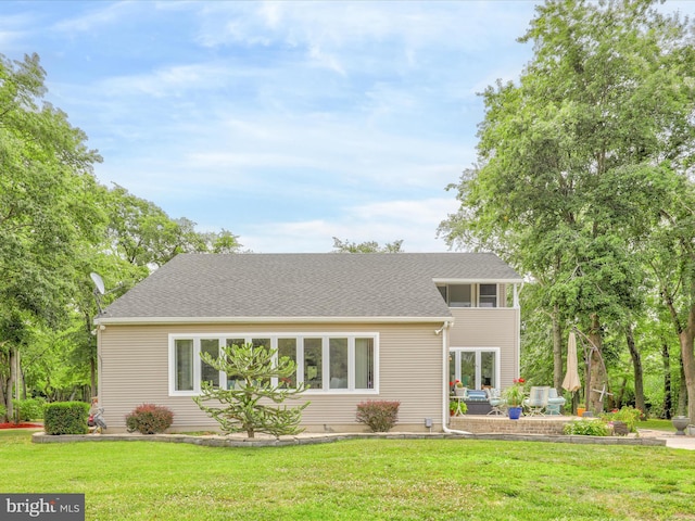 rear view of property with a patio area and a lawn