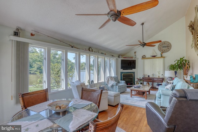 sunroom / solarium featuring lofted ceiling and a healthy amount of sunlight