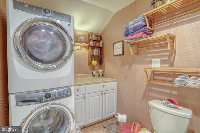 clothes washing area with stacked washer and dryer