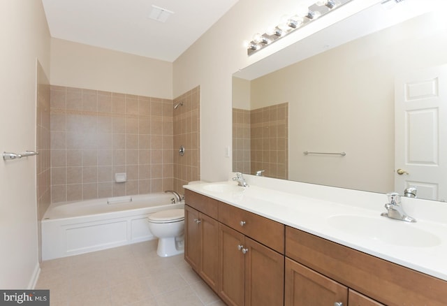 full bathroom featuring toilet, vanity, tiled shower / bath combo, and tile patterned floors