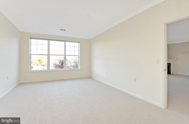 empty room featuring light carpet and crown molding