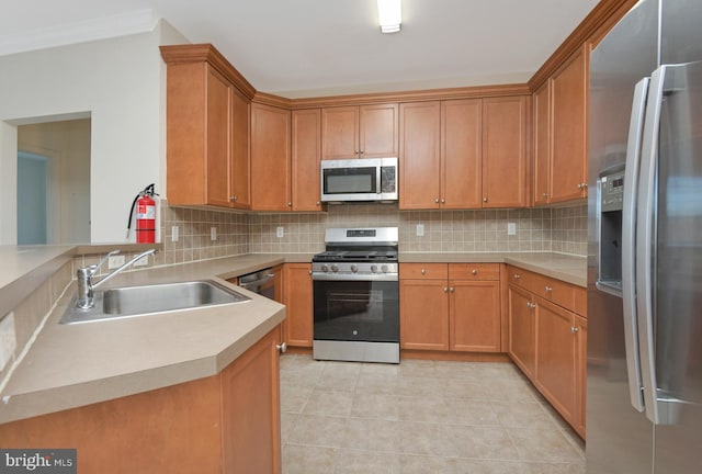 kitchen with decorative backsplash, sink, light tile patterned flooring, and appliances with stainless steel finishes