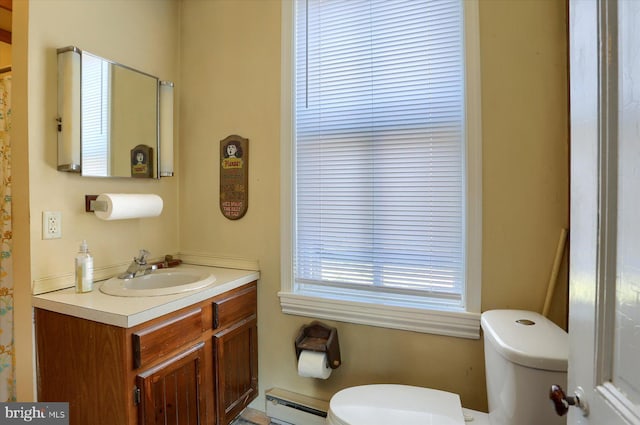 bathroom with vanity, toilet, and a baseboard radiator