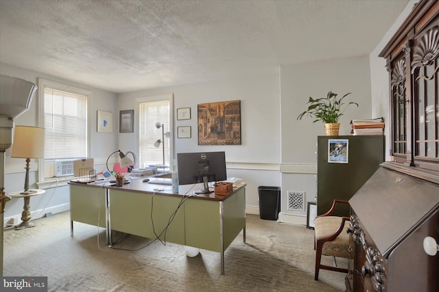 office with cooling unit, light colored carpet, and a textured ceiling