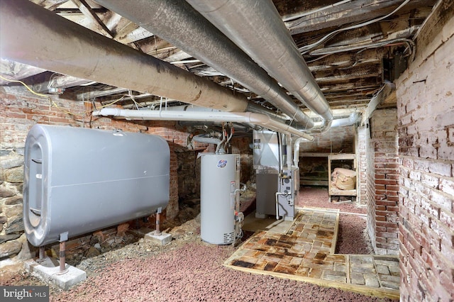 basement featuring gas water heater, brick wall, and heating unit