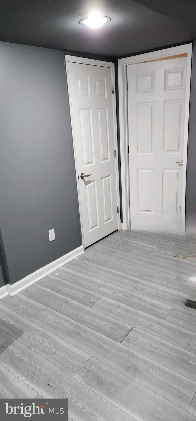 unfurnished bedroom with light hardwood / wood-style floors and a closet