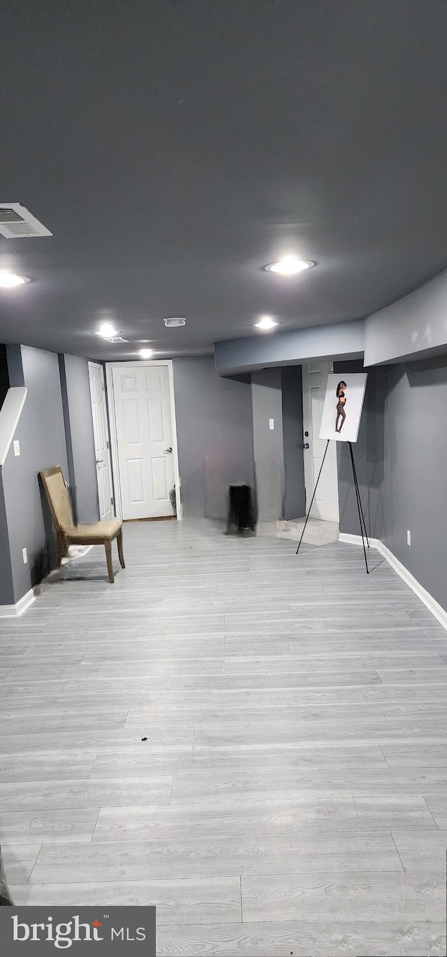 basement featuring light hardwood / wood-style flooring