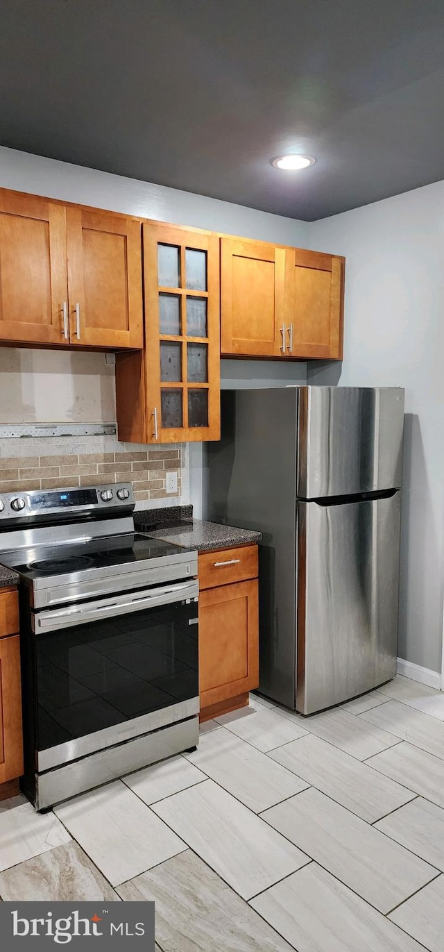 kitchen featuring ventilation hood and appliances with stainless steel finishes