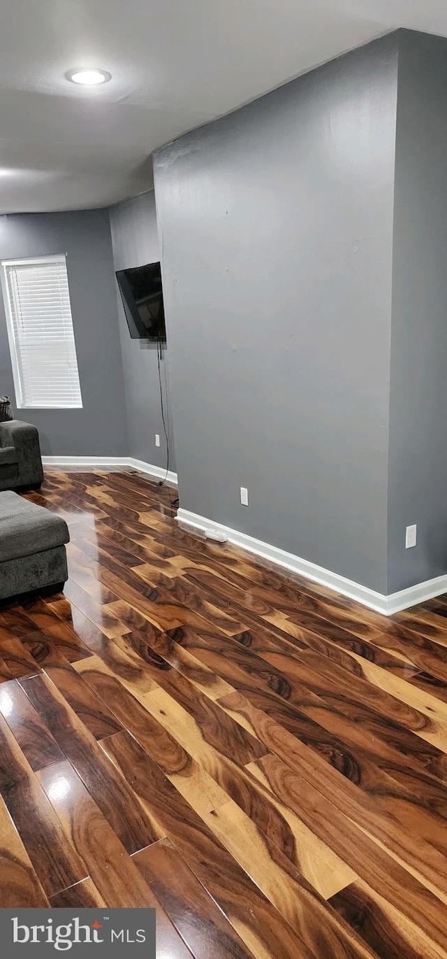 unfurnished living room featuring dark hardwood / wood-style floors