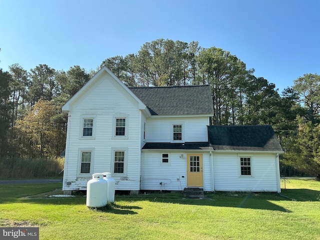 back of property featuring a yard