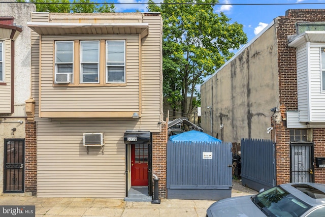 view of property exterior featuring a wall mounted air conditioner