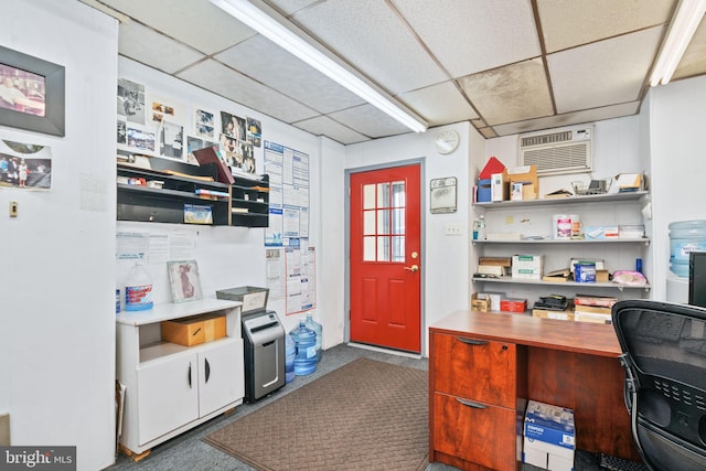 office space featuring a paneled ceiling and a wall mounted air conditioner