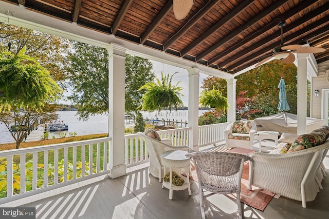 view of patio / terrace featuring a water view and ceiling fan