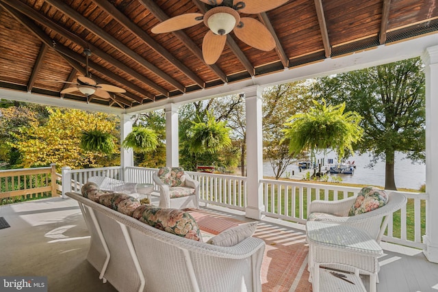 wooden deck with a porch and a water view