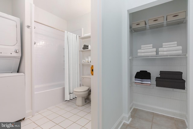 bathroom with toilet, shower / bath combination with curtain, stacked washing maching and dryer, and tile patterned floors