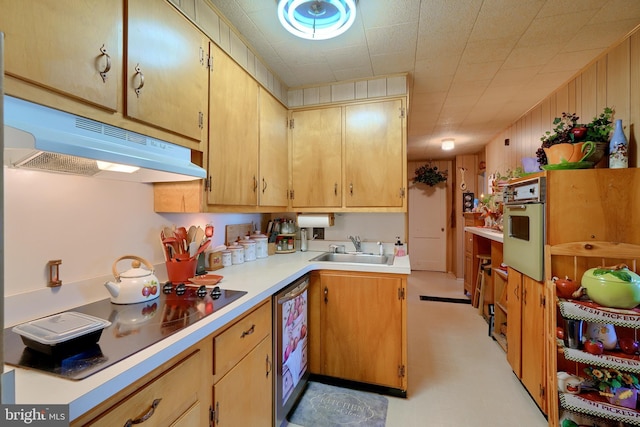 kitchen featuring wall oven, wooden walls, sink, and black electric stovetop