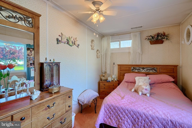 carpeted bedroom with crown molding and ceiling fan