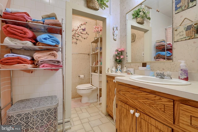 bathroom featuring vanity, a baseboard radiator, and toilet