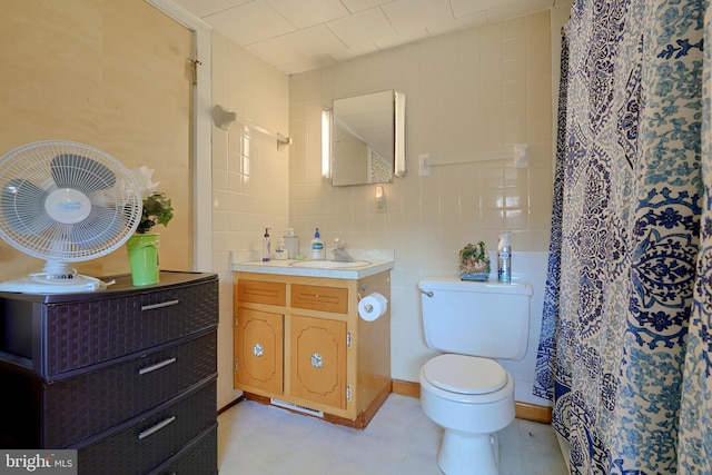 bathroom featuring a shower with curtain, vanity, tile walls, and toilet