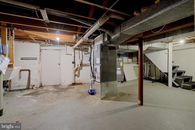 basement featuring electric water heater and heating unit